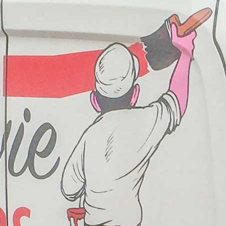 close up view of man painting with cut vinyl graphic on decorators van