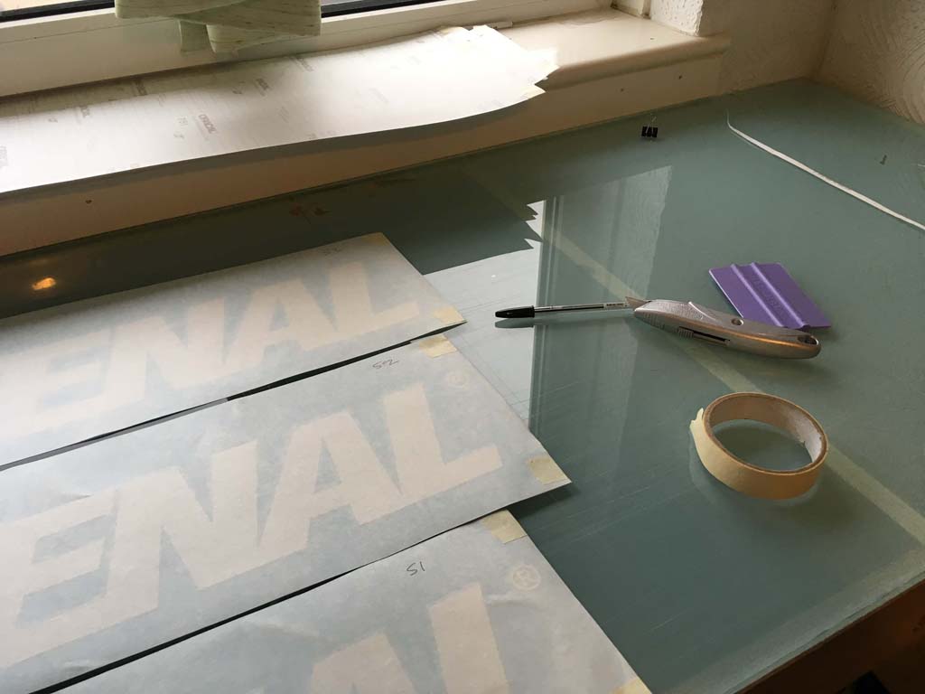 set of fastenal stickers on cutting deslk with various signmaking tools