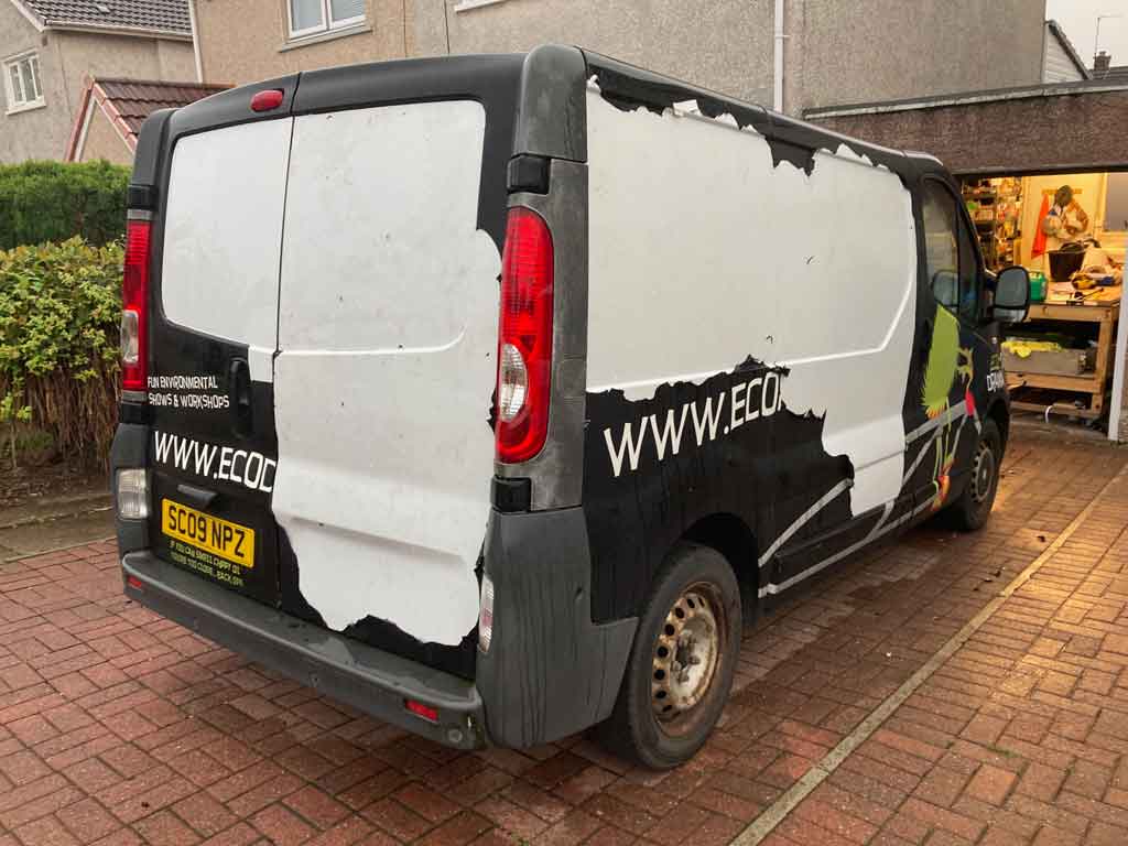 Van having had about half of its wrap removed